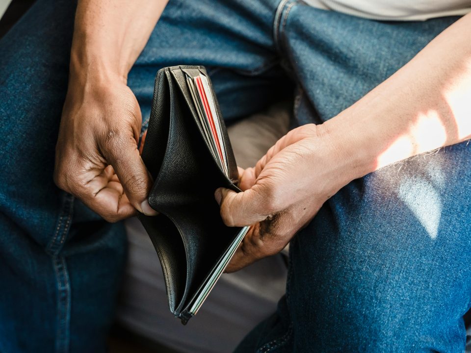 A man opening an empty wallet