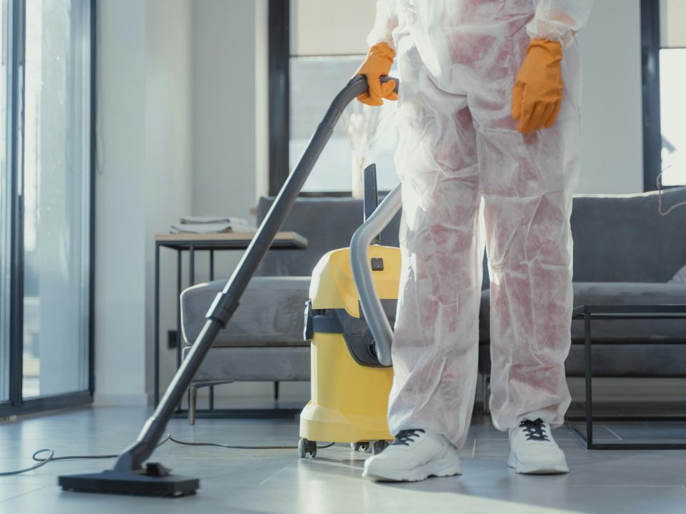 Person in protective clothing cleaning a floor